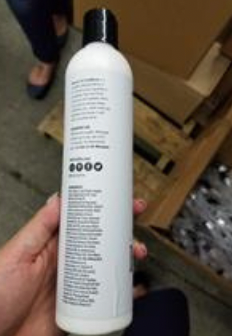 A person holding a white can Description automatically generated